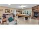 Large living room with a fireplace, tile flooring, and a leather couch at 2618 Titania Rd, Englewood, FL 34224