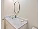 Bathroom vanity featuring a glass vessel sink, marble countertop, and oval mirror at 27416 Natal Dr, Punta Gorda, FL 33983