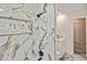 Stunning shower with marble-look tile and easy access to the bathroom at 27416 Natal Dr, Punta Gorda, FL 33983