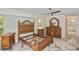 This main bedroom has tile floors, multiple windows, ceiling fan and wooden furniture set at 27416 Natal Dr, Punta Gorda, FL 33983
