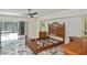 Bright bedroom with a ceiling fan, a sliding door to the lanai, and a matching set of furniture at 27416 Natal Dr, Punta Gorda, FL 33983