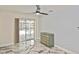 Bedroom boasts fan, screened patio access, and beautiful marble-look flooring at 27416 Natal Dr, Punta Gorda, FL 33983
