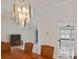 Dining room with chandelier and table, leading to the kitchen and living room with marble floors at 27416 Natal Dr, Punta Gorda, FL 33983