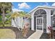 Elegant front door with decorative glass detailing and sidelights, set within a charming archway and manicured landscaping at 27416 Natal Dr, Punta Gorda, FL 33983