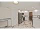 Spacious kitchen with stainless steel appliances, white cabinets, and eat-in space by the built in desk at 27416 Natal Dr, Punta Gorda, FL 33983