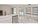 The open kitchen features white cabinets, a stainless-steel dishwasher, and a view of the outdoor pool at 27416 Natal Dr, Punta Gorda, FL 33983