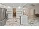 Well-lit kitchen with white cabinets, stainless steel appliances, and marble floors at 27416 Natal Dr, Punta Gorda, FL 33983