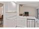This kitchen features white cabinetry, stone countertops, and stainless-steel appliances at 27416 Natal Dr, Punta Gorda, FL 33983