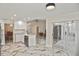 This spacious kitchen features white cabinets and countertops and stainless-steel appliances and fixtures at 27416 Natal Dr, Punta Gorda, FL 33983