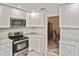 A beautifully appointed kitchen with a stylish stove, microwave, and marble countertops at 27416 Natal Dr, Punta Gorda, FL 33983