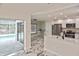 Bright kitchen featuring stainless steel appliances, island with breakfast bar, and sliding doors to the pool at 27416 Natal Dr, Punta Gorda, FL 33983
