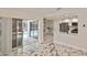 Living area showcases sliding glass doors to pool, connecting the kitchen, and marble flooring at 27416 Natal Dr, Punta Gorda, FL 33983