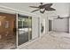 Covered outdoor patio with tile flooring, ceiling fans, and sliding glass doors to the interior and pool at 27416 Natal Dr, Punta Gorda, FL 33983