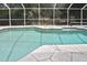 Inviting screened-in pool with stone decking, perfect for relaxing and enjoying the outdoors in comfort and style at 27416 Natal Dr, Punta Gorda, FL 33983