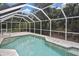 Screened-in pool offers a perfect blend of relaxation and entertainment, embraced by a backdrop of flourishing greenery at 27416 Natal Dr, Punta Gorda, FL 33983