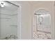 View of the Walk-In Closet and arched entry to the bathroom with marble floors and modern fixtures at 27416 Natal Dr, Punta Gorda, FL 33983