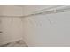 Walk-in closet features metal shelving and beautiful marble-look tile flooring at 27416 Natal Dr, Punta Gorda, FL 33983