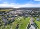 Extensive community and golf course are captured in an aerial view highlighting the coastal setting at 27467 Janzen Ct, Englewood, FL 34223