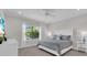 Comfortable bedroom with a window view, a ceiling fan, and neutral decor at 27467 Janzen Ct, Englewood, FL 34223