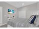 Well-lit bedroom with beach view on television and neutral toned linens at 27467 Janzen Ct, Englewood, FL 34223