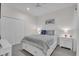 This lovely bedroom is furnished with white furniture and neutral walls at 27467 Janzen Ct, Englewood, FL 34223