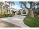 Clubhouse featuring well-maintained landscaping, a porte-cochere, and inviting architectural details at 27467 Janzen Ct, Englewood, FL 34223