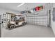 Spacious garage includes a golf cart, overhead storage racks, and an automatic garage door at 27467 Janzen Ct, Englewood, FL 34223