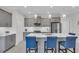 Well-lit kitchen featuring stainless appliances, an island with seating, and contemporary gray cabinetry at 27467 Janzen Ct, Englewood, FL 34223