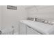 Clean laundry room features a washer, dryer, wire basket and laundry-themed wall decor at 27467 Janzen Ct, Englewood, FL 34223