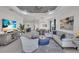 Open-concept living room with stylish furniture and decor leading into a dining area and kitchen at 27467 Janzen Ct, Englewood, FL 34223