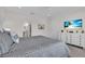 This spacious main bedroom features neutral walls, white trim, and a beach view television at 27467 Janzen Ct, Englewood, FL 34223