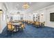 Bright meeting room with comfortable seating, built-in shelving, and stylish decor at 27467 Janzen Ct, Englewood, FL 34223