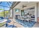Relax on the screened patio with a ceiling fan, lake view, and easy access to the living room at 27467 Janzen Ct, Englewood, FL 34223
