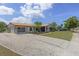 Charming single-story home featuring a well-kept lawn, landscaped garden, and ample driveway parking at 318 Venice East Blvd, Venice, FL 34293