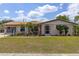 Charming single-story home featuring a well-manicured lawn and a welcoming front entrance at 318 Venice East Blvd, Venice, FL 34293