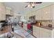 Updated eat-in kitchen features tile backsplash, ample storage, and modern appliances at 318 Venice East Blvd, Venice, FL 34293