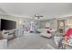 Open-concept living room with a cozy fireplace and access to an enclosed porch at 318 Venice East Blvd, Venice, FL 34293