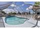 A screened-in pool with a shed visible in the background, perfect for relaxation and entertaining at 318 Venice East Blvd, Venice, FL 34293