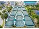 Aerial perspective of tennis courts surrounded by lush trees and greenery; an ideal outdoor recreational space at 3181 Alta Vista St, Sarasota, FL 34237