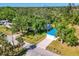 Eye-catching aerial view of a quaint home with a striking blue roof nestled among lush greenery at 352 Glenwood Ave, Osprey, FL 34229