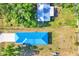Aerial view of property with blue roof, featuring lush landscaping, and proximity to neighboring homes at 352 Glenwood Ave, Osprey, FL 34229