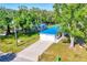 Aerial view of home with a blue metal roof and a long driveway at 352 Glenwood Ave, Osprey, FL 34229