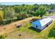 Aerial view of home and large yard featuring fire pit, shed, and surrounding trees for privacy at 352 Glenwood Ave, Osprey, FL 34229