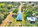 Aerial view of charming home with blue roof, showcasing its neighborhood, landscaping, and proximity to nearby amenities at 352 Glenwood Ave, Osprey, FL 34229