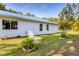 Landscaped backyard featuring a white lawn chair at 352 Glenwood Ave, Osprey, FL 34229