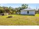 View of grassy backyard with fire pit and small storage shed at 352 Glenwood Ave, Osprey, FL 34229