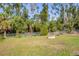 Spacious backyard with manicured lawn and a fire pit at 352 Glenwood Ave, Osprey, FL 34229