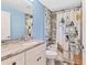 A stylish bathroom with a white vanity and a shower with grey tiles, creating a sleek appearance at 352 Glenwood Ave, Osprey, FL 34229