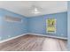A relaxing bedroom with wood flooring, a ceiling fan, and light blue walls with natural light at 352 Glenwood Ave, Osprey, FL 34229