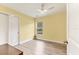 An airy bedroom with yellow walls, wood flooring and a view from the window at 352 Glenwood Ave, Osprey, FL 34229